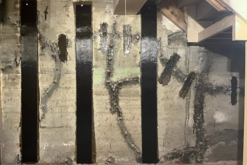 Repaired crack in a finished basement wall after professional concrete repair