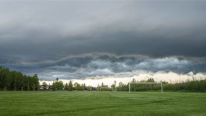 Storm clouds over a field during heavy rain in Edmonton